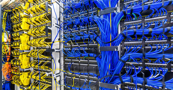 Rack with generic Ethernet cat5e cables, part of a large company data center.